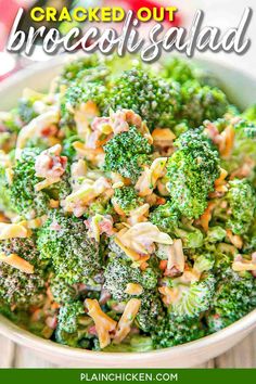 a white bowl filled with broccoli and other food on top of a wooden table