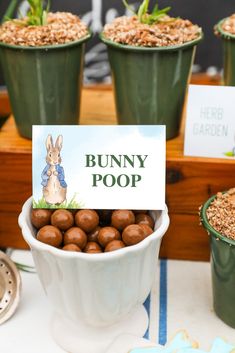 there is a bunny poop sign in the bowl with some chocolates on it