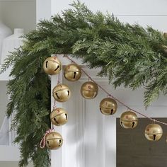 a christmas garland with bells hanging from it