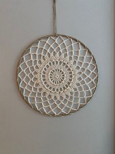 a crocheted doily hanging on the wall