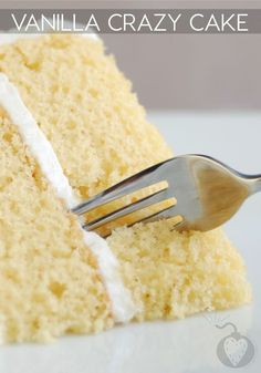 a piece of vanilla crazy cake on a white plate with a fork sticking out of it