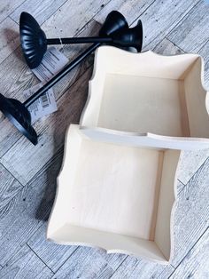 two serving trays with spoons on the floor