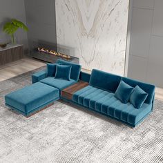 a blue sectional couch sitting on top of a rug in front of a fire place