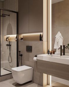 a white toilet sitting next to a bathroom sink