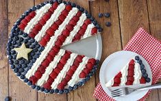 an american flag cake on a plate with a slice cut out and ready to be eaten