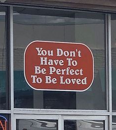 a red sign that says you don't have to be perfect to be loved