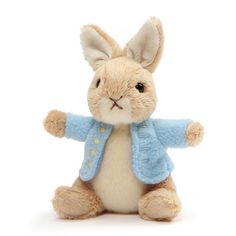 a stuffed rabbit with a blue jacket on it's head and ears, sitting in front of a white background