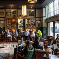 a group of people sitting at tables in a bar