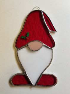 a stained glass ornament with a santa hat