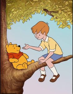 a boy sitting on top of a tree next to a winnie the pooh stuffed animal