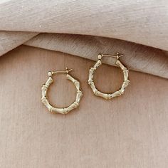 "Gold-Filled Hoop Earrings, Bamboo Hoop Earrings, Gold Hoops, Gold Textured Hoops ★ HIGHEST QUALITY 18k Gold Filled Bamboo Hoops ★ 22mm Diameter ★ These earrings are tarnish-resistant and WATERPROOF. It can be worn in the shower and water without changing colors. ★ These earrings are hypoallergenic and perfect for sensitive skin. ★ Our jewelry is made to last with everyday wear! 18K GOLD FILLED DETAILS: Gold-filled jewelry is an affordable alternative to solid gold. It consists of a genuine laye Golden Bamboo, Earrings Gold Hoops, Bamboo Hoop Earrings, Bamboo Earrings, Hoops Gold, Bamboo Design, Gold Filled Hoops, Hoop Earrings Gold, Layered Jewelry