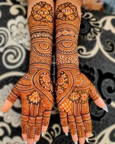 two hands with henna designs on them