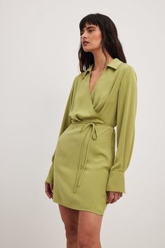 Overlap Classic Mini Dress Green Solid Long Sleeve Wrap Dress For Spring, Spring Long Sleeve Solid Wrap Dress, Chic Solid Color Long Sleeve Wrap Dress, Belted Mini Dress In Solid Color, Solid Long Sleeve Wrap Dress For Work, Long Sleeve Solid Wrap Dress For Work, Long Sleeve Solid Color Wrap Dress For Fall, Long Sleeve Wrap Dress For Date Night, Fall Long Sleeve Solid Wrap Dress