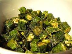 a white bowl filled with chopped up green vegetables