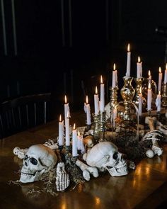 a table topped with skulls and candles