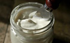 a spoon in a jar filled with yogurt