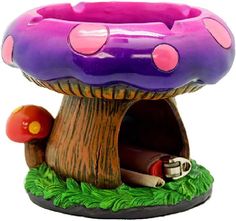 a toy mushroom house with a pink and purple roof