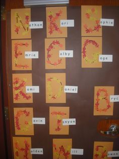 a door decorated with fall leaves and words that spell out the word abc, d