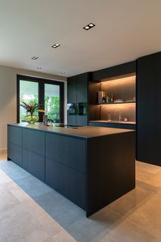 a large kitchen with an island in the middle and lots of counter space next to it