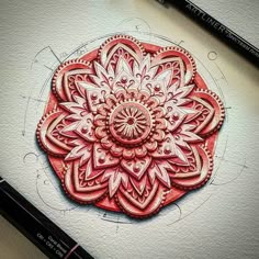 a drawing of a red flower on paper