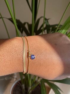 🌟 Gold Filled Evil Eye Bracelet Add a touch of mystique and style to your wrist with our Gold Filled Evil Eye Bracelet! This piece is perfect as a standalone accent or for stacking alongside your favorite bracelets. 🌟 Features a delicate 1mm dainty box chain ���🌟 Adorned with a striking 6.5mm Evil Eye charm 🌟 Adjustable fit for comfort 🌟 Crafted from luxurious 18K Gold Filled Brazilian Gold Elevate your style and ward off negativity with this chic accessory! 💫 If you would like to purchase th Gold Evil Eye Bracelet, Gold Arm Band, Herringbone Bracelet, Evil Eye Art, Brazilian Gold, Gold Armband, Eye Bracelet, Evil Eye Charm, Evil Eye Bracelet