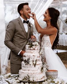 a bride and groom feeding each other cake