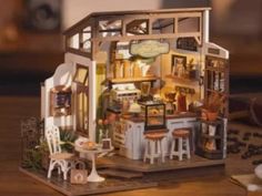 a doll house with furniture and accessories on a table