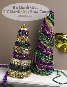 two small christmas trees made out of bead and sequins on a shelf