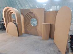 several cardboard shapes are on display in a warehouse