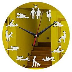 a clock with white silhouettes of men and women on yellow walls in a hallway