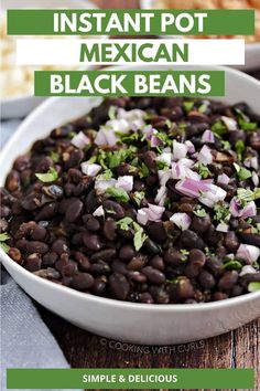 a white bowl filled with black beans on top of a wooden table