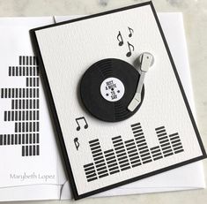 a record player is on top of some music notes and a pair of tape recorders