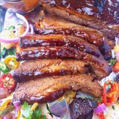 barbecue ribs and vegetables on a plate with sauce