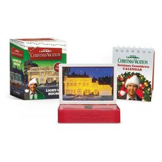 three christmas greeting cards and a calendar on a stand with an ornament in front of them