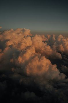 the sky is filled with clouds as seen from an airplane