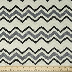 a ruler is next to a black and white zigzag pattern on fabric