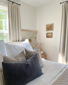 a bed with white sheets and pillows in front of a window that reads therapy home project follow