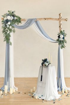 a wedding arch decorated with flowers and candles