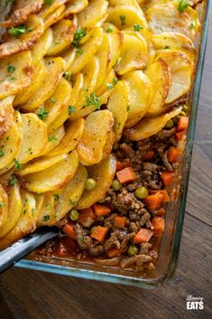 a casserole dish with potatoes, meat and peas