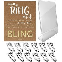 wedding rings are shown in front of a card with the words ring out on it