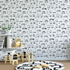 the wallpaper in this children's room is decorated with black and white cars