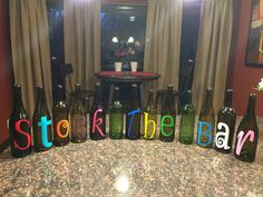 six wine bottles with the words stock the bar painted on them