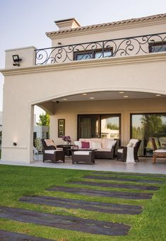 an outdoor living area with patio furniture and grass