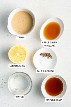 the ingredients to make an apple cider recipe are shown in bowls on a white surface