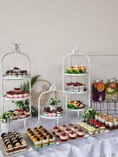 a table topped with lots of different types of cakes and cupcakes next to each other