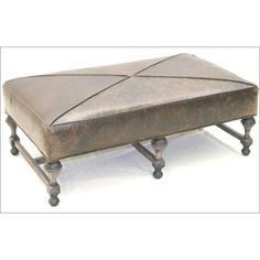 an ottoman that is made out of wood and leather