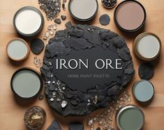 an iron ore is surrounded by various paint colors and sizes on a wooden surface with the words iron ore above it