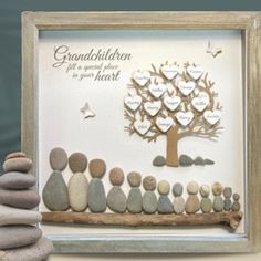 a family tree made out of rocks sitting on top of a table next to a pile of stones