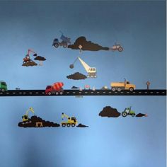 there are many vehicles and trucks on the wall in this child's nursery room