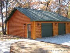 a log cabin with two garages in the front and one on the other side